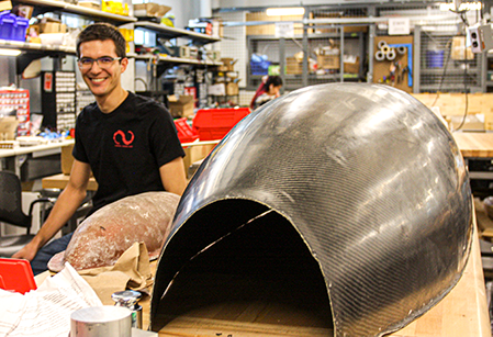 Alec Wyatt with the Cornell Hyperloop pod shell