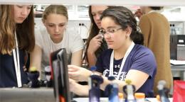 CURIE Academy participants gather in a lab to work on a research project