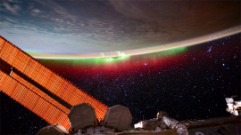 The Earth’s atmosphere, featuring the aurora borealis, is pictured from the International Space Station.