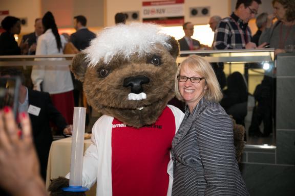 June Losurdo poses with Touchdown the bear, Cornell's mascot at an alumni event