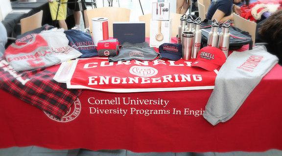 Table display of Cornell University, Cornell Engineering, and DPE branded merchandise