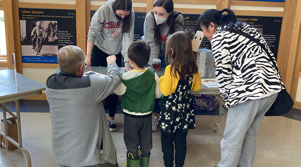 students work with children at workshop event